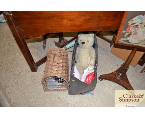 A well loved vintage Teddy bear; and a wicker pet carrier 