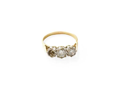 An 18 Carat Gold Diamond Three Stone Ring, the graduated round brilliant cut diamonds in white illusion settings, to a yellow
