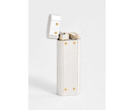 A Les Must de Cartier Roller Gas Lighter, in brushed steel and with gilt accents, numbered E04752, in fitted gilt-tooled red 