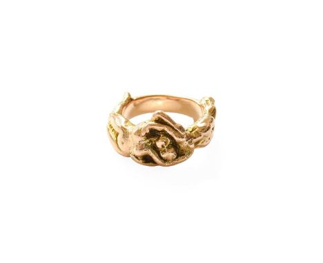 A 9 Carat Gold Ring, depicting intertwined figures, finger size MGross weight 11.4 grams.