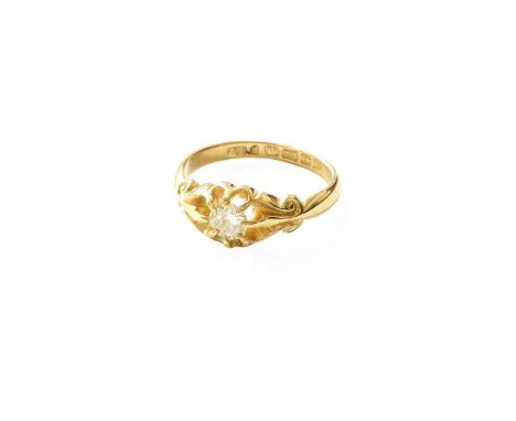 An 18 Carat Gold Solitaire Ring, the round brilliant cut diamond in a yellow claw setting, to a scroll shoulder plain polishe