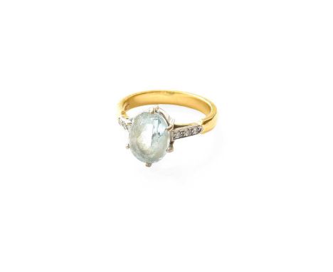An Aquamarine Ring, the oval cut aquamarine in a white claw setting, to round brilliant cut diamond set shoulders, on a yello