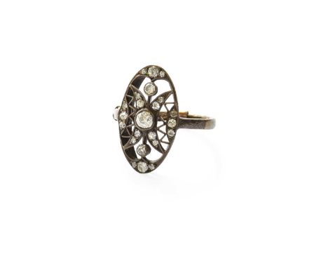 A Diamond Ring, the pierced and openwork oval frame decorated with old cut diamonds, in white rubbed over and millegrain sett