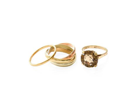 A 9 Carat Gold Smoky Quartz Ring, finger size J1/2; A 9 Carat Gold Russian Band Ring, finger size L1/2; and A Band Ring, mark