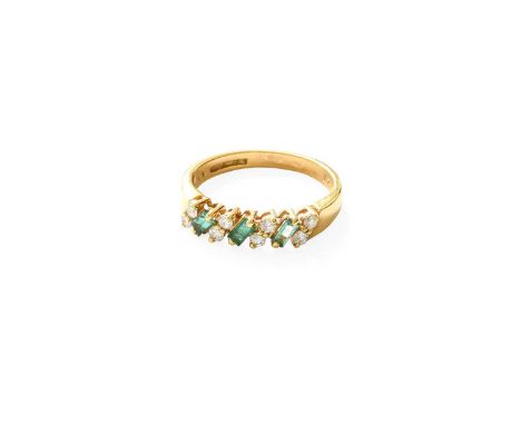 An 18 Carat Gold Emerald and Diamond Half Hoop Ring, three baguette cut emeralds alternate with pairs of round brilliant cut 