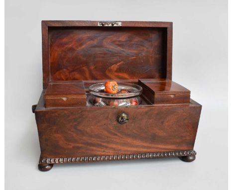 A Regency Mahogany Tea Caddy, with turned mouldings, compressed bun feet and housing two canisters and a glass mixing bowl, 3