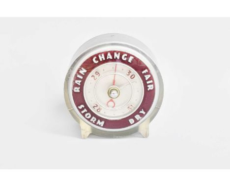An Art Deco Aneroid Barometer, makers Joseph Lucas Ltd, in perspex case with ruby chapter ring, 11cm high 