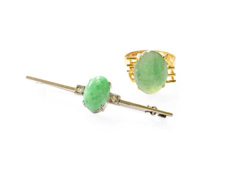 A Jade and Diamond Brooch, the oval cabochon jade in a white claw setting, flanked by old cut diamonds in square settings, to