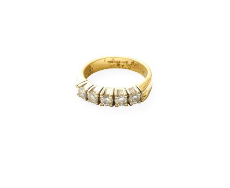 An 18 Carat Gold Diamond Five Stone Ring, the round brilliant cut diamonds in white claw settings, to a yellow plain polished
