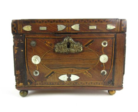 A 19th century folk art mahogany tea caddy inlaid with mother of pearl, brass, boxwood, rosewood, ebony and parquetry banding