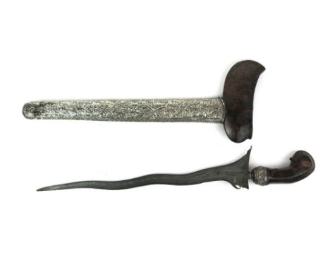 A Malaysian Kriss dagger, having a double edged wave blade, a white metal handle neck and a white metal scabbard cover decora