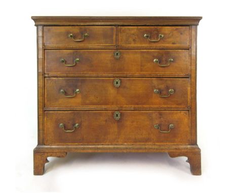 An early 18th century and later walnut, oak and elm chest of two short over three long drawers on bracket feet, h. 95 cm, w. 