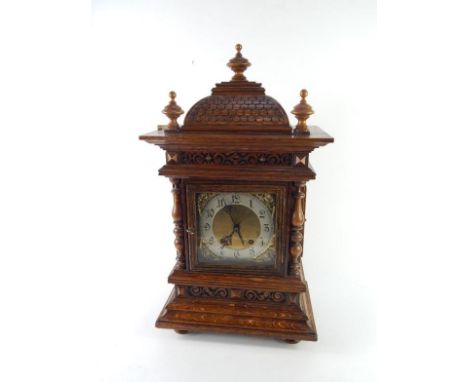 A Victorian oak cased bracket clock, square brass dial with embossed cherub's head spandrels, silvered chapter ring bearing A