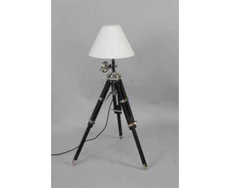 A retro style floor lamp, with chrome fittings, on ebonised adjustable tripod base, 101cm high
