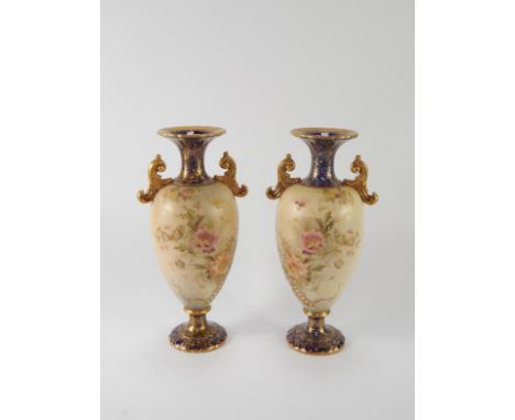 A pair of Carltonware late 19thC Arvista vases, of twin handled baluster form decorated with flowers against a black ground, 