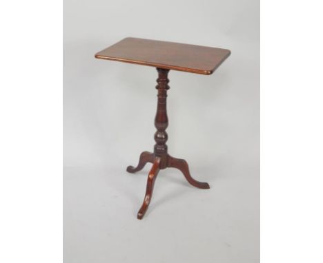 A Victorian mahogany occasional tilt top table, with a rectangular top, on a turned column and tripod base, 50cm wide.