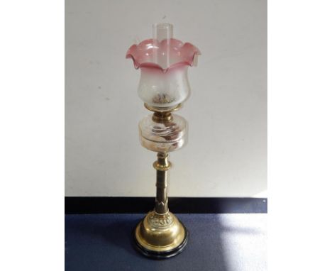 A Duplex brass Gothic style oil lamp, with a faceted clear glass reservoir and an etched floral frosted glass shade with a pi