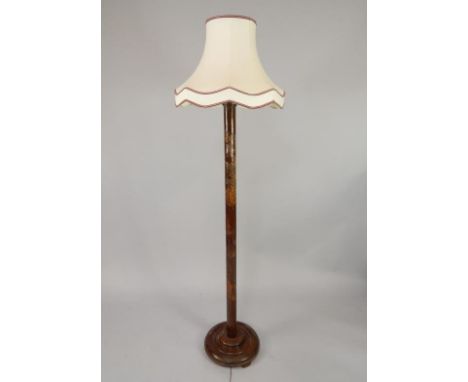 An oriental hardwood standard lamp, carved with buildings, flowering branches etc., 200cm high