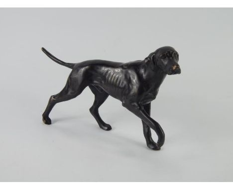 A bronze sculpture of a labrador, modelled with front right paw raised, 26.5cm long.