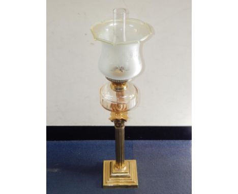 A Duplex brass Corinthian column oil lamp, with a faceted clear glass reservoir, and an etched floral frosted glass shade, 77