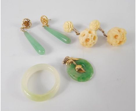 A Chinese jade bi disc pendant, with yellow metal leaf and loop attachment, pair of jade drop earrings, white jade ring, and 