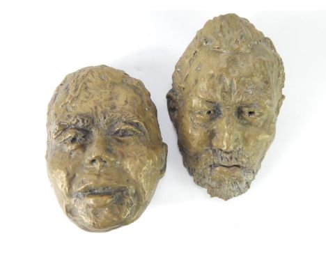 Two bronze painted terracotta wall masks, 20thC, one of a youth, the other an old man, 74cm and 76cm long respectively.