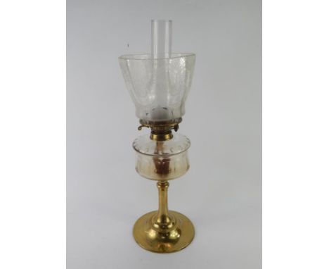 A Victorian brass oil lamp, with cut glass reservoir, the shade etched with flowers, etc, 82cm high.