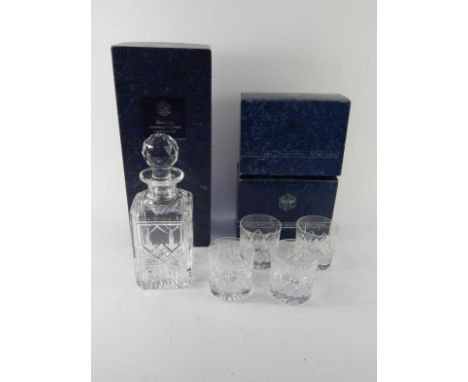 A Stuart Crystal decanter and stopper, in original box, and four tumblers.