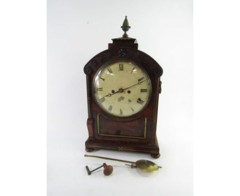 A Regency bracket clock, with eight day twin train movement and white painted circular dial with Arabic numerals, in an arche