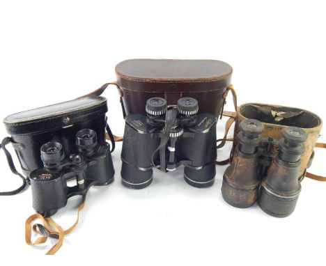 A pair of Wilkinson 10x15 binoculars, a pair of military style field binoculars and a pair of Lewis Quorn binoculars, (3).