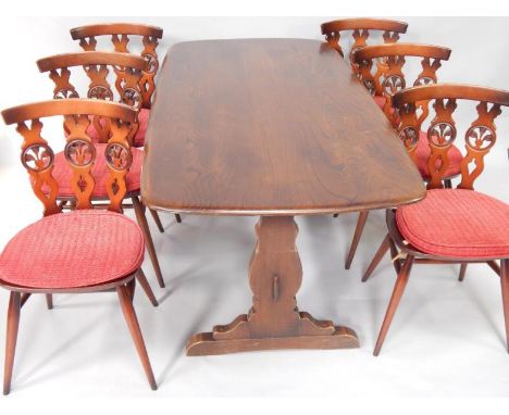 An Ercol oak dining table, raised on trestle end supports united by a stretcher, 152cm x 76cm x 72cm, together with six dinin