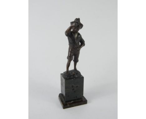 An early 20thC bronze figure of a boy, stamped ECHTE BRONCE, raised on a marble base, 16.5cm high, (AF).