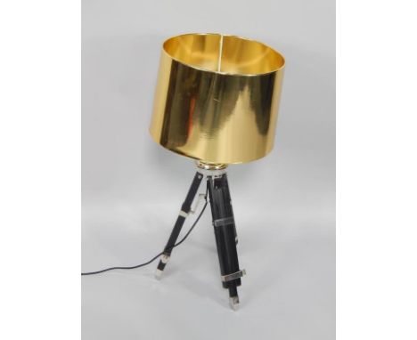 A retro style adjustable standard lamp, with gold shade, chrome plated fittings and ebonised adjustable tripod base,.