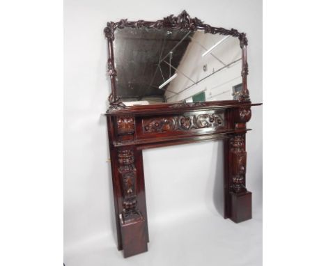 A mahogany fire surround and matching overmantel mirror, in the Victorian style, the mirror with a leaf and foliate carved fr