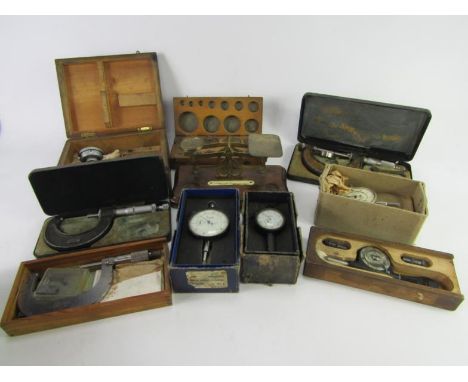 A collection of engineer's micrometers and gauges, rev counter, brass scale weights, etc,.