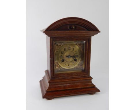 A Victorian oak cased mantel clock, brass dial bearing Arabic numerals, eight day Junghams movement with coil strike, with ke