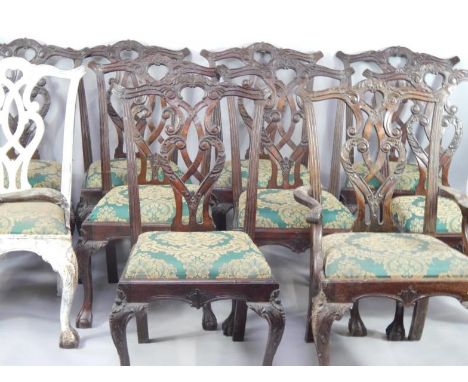 A set of ten reproduction Chippendale style mahogany dining chairs, with carved foliate scroll decoration and drop-in seats o