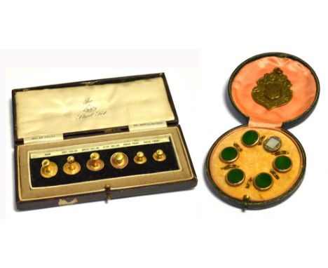 A cased set of yellow metal dress studs with jade green centres, a cased set of The O.P. yellow metal stud set and am 18ct go