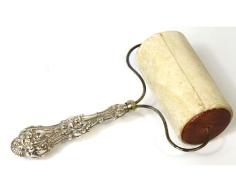 A vintage American roller blotter with silver rococo style handle.