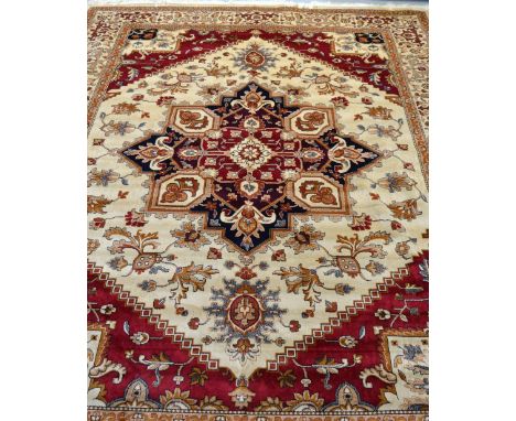 A beige ground Heriz carpet, 280 x 200cm.