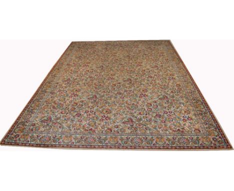 A large British woven beige ground floral decorated Persian carpet, approx 310 x 230cm.