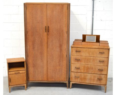 A mid 20th century light oak bedroom suite comprising two door wardrobe with fitted interior, width 92cm, matching combinatio