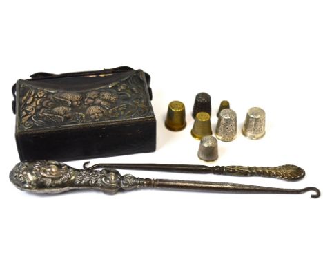 A leather carrying case with hallmarked silver mount decorated with cherubs, containing a common prayer book and a hymn book,