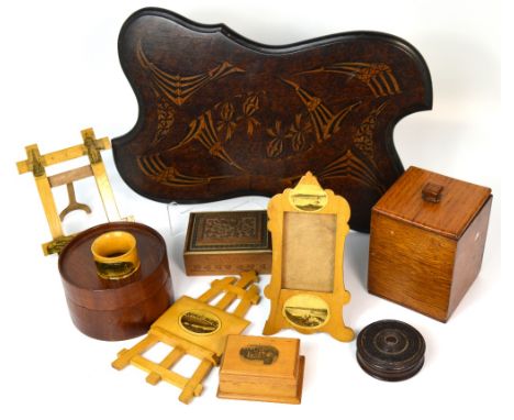 A small quantity of treen to include Mauchline ware, miniature easels, napkin rings, an early 20th century oak tea caddy and 