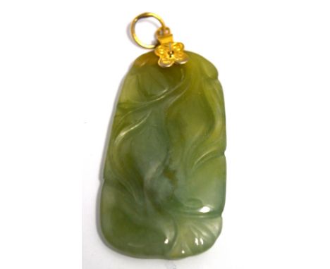 A jade pendant with a yellow metal mount.
