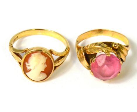 A 14ct gold ring with a central pink stone set in a scrolling leaf design, size K and a yellow metal ring set with cameo, siz