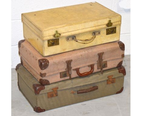 Three vintage suitcases to include two canvas covered examples. 