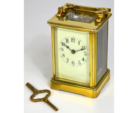 A 19th century brass carriage clock with white enamel dial set with Arabic numerals, height 10cm. CONDITION REPORT In working