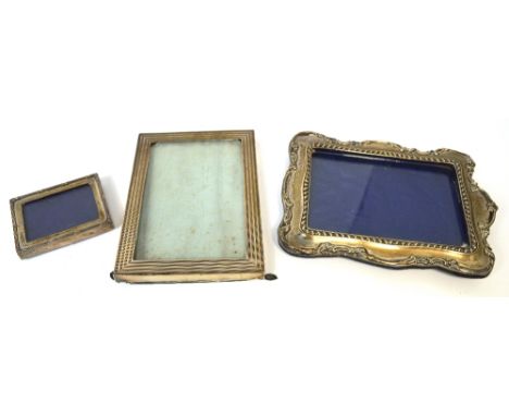 Three hallmarked silver picture frames, various sizes, an engine turned square picture frame, a scroll and bead decorated pic