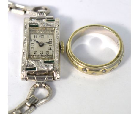 A lady's vintage white metal cocktail watch, the rectangular dial set with Arabic numerals within green and clear stone set f